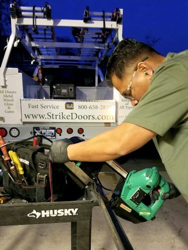 A man working on a custom door for the door company Strike Doors, LLC in Sacramento, CA